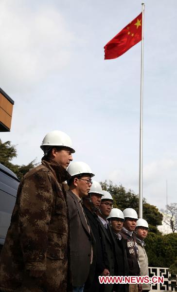 Members of the working group of the Chinese Embassy stand in line before their departure in Tokyo, March 14, 2011. 