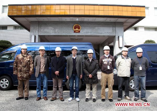 Members of the working group of the Chinese Embassy pose for a group photo before their departure in Tokyo, March 14, 2011. 