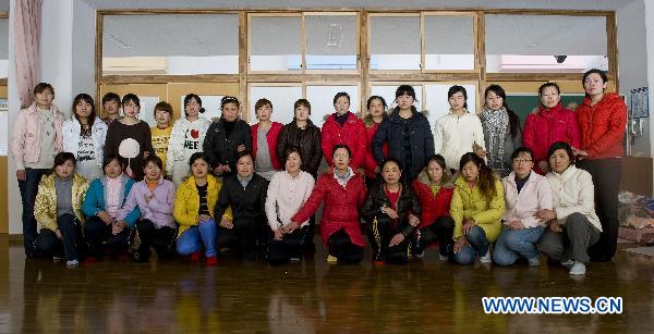 Chinese Graduate students pose for photo at a refuge in Ofunato city of Japan&apos;s northeastern Iwate Prefecture, March 14, 2011. 