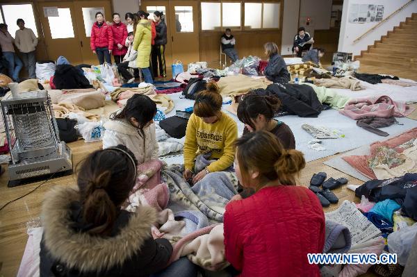 Chinese Graduate students rest at a refuge in Ofunato city of Japan&apos;s northeastern Iwate Prefecture, March 14, 2011. 