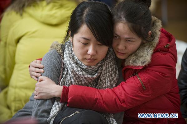 Chinese Graduate students hug with each other at a refuge in Ofunato city of Japan&apos;s northeastern Iwate Prefecture, March 14, 2011. 