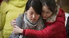 Chinese Graduate students hug with each other at a refuge in Ofunato city of Japan's northeastern Iwate Prefecture, March 14, 2011.