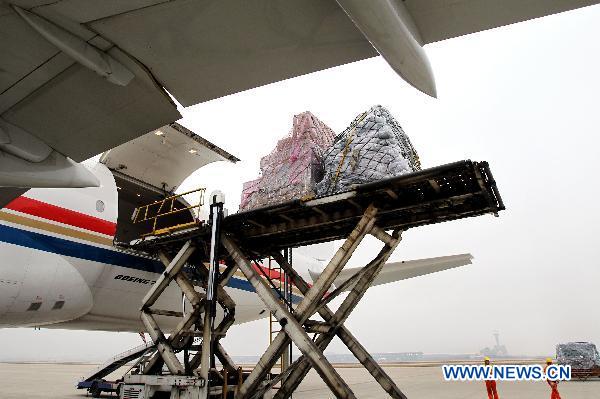 Relief materials are loaded to a plane at Shanghai Pudong International Airport in Shanghai, east China, March 14, 2011.