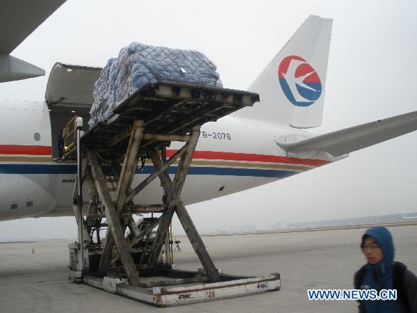 Relief goods offered by Chinese government to quake-hit Japan are loaded into a plane in Shanghai Pudong International Airport in Shanghai, east China, March 14, 2011. 