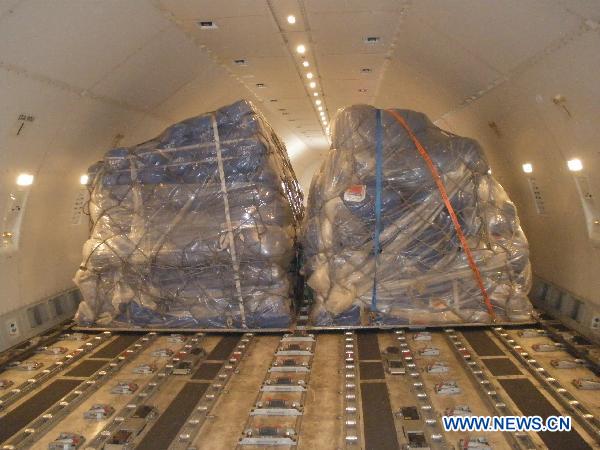 Relief goods offered by Chinese government to quake-hit Japan are loaded into a plane in Shanghai Pudong International Airport in Shanghai, east China, March 14, 2011. 