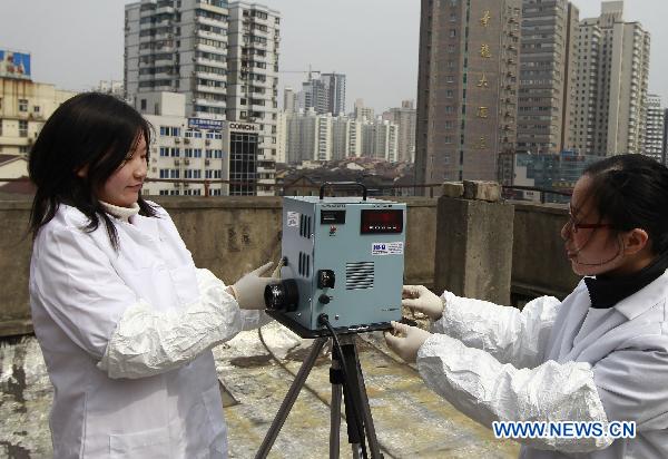 A staff member shows the equipment for checking the radiation level at an environment supervision station in Shanghai, east China, March 15, 2011.