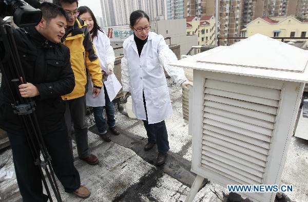 A staff member shows the equipment for checking the radiation level at an environment supervision station in Shanghai, east China, March 15, 2011.