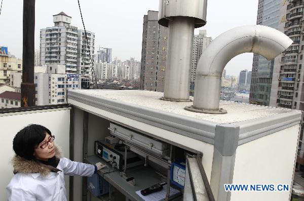 A staff member manipulates the equipment for checking the radiation level at an environment supervision station in Shanghai, east China, March 15, 2011.