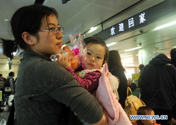 A Chinese national evacuated from quake-hit Japan waits for check at the Dalian Zhoushuizi International Airport in Dalian, northeast China's Liaoning Province, March 16, 2011.