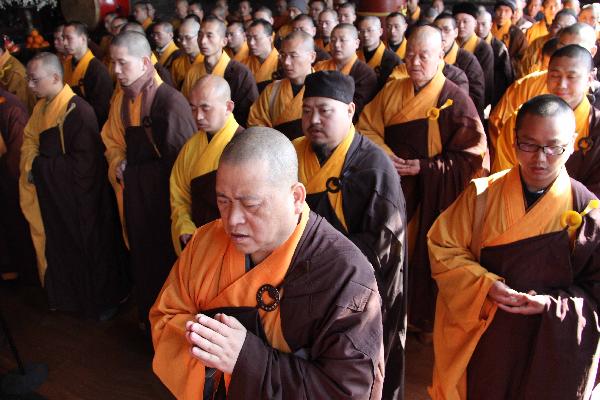 Members of Buddhist Association of China pray for the lost lives during the earthquake that took place in Japan last week in Beijing, capital of China, March 16, 2011. 