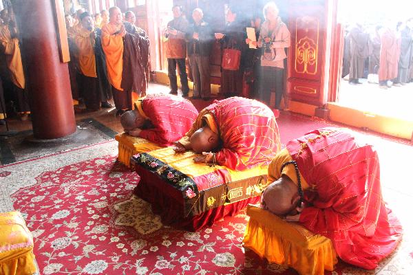 Members of Buddhist Association of China pray for the lost lives during the earthquake that took place in Japan last week in Beijing, capital of China, March 16, 2011. 