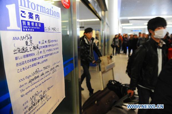 Chinese passengers departed from Japan arrive at an airport in Qingdao, east China's Shandong Province, March 16, 2011.