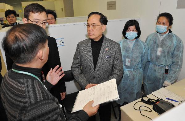 Donald Tsang (C), chief executive of the Hong Kong Special Administrative Region (HKSAR), inspects the special health counter at the Hong Kong International Airport, in Hong Kong, south China, March 16, 2011. 