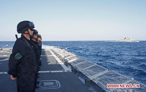 Special forces aboard China's seventh escort flotilla missile frigate 'Zhoushan' welcome the arrival of the eighth escort flotilla in the Gulf of Aden on March 16, 2011. 