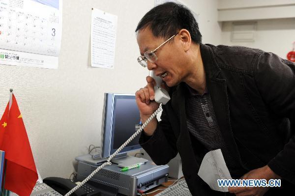 Liu Zhijian, Chinese Consul General in Sapporo, answers a phone call in Sapporo, Japan, March 18, 2011.