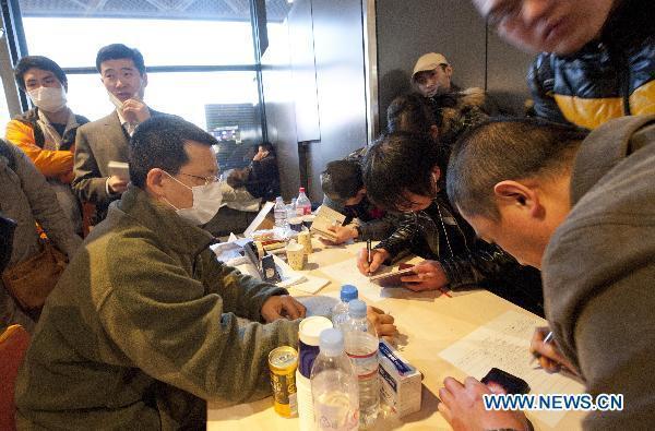 Chinese nationals register with the help of the members of Chinese Embassy at Narita airoprt in Tokyo, Japan, March 17, 2011. 