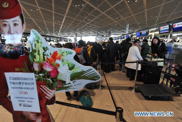 Chinese nationals wait for evacuation at the counter of Air China at Narita airoprt in Tokyo, Japan, March 17, 2011. 