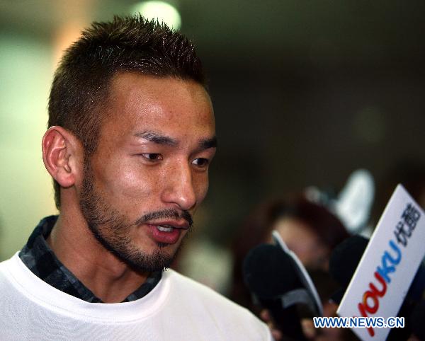 Former Japanese soccer player Nakata Hidetoshi receives an interview during the 'Fight and Smile' fund-raising party for the earthquake-hit Japan held in Taipei, southeast China's Taiwan, March 18, 2011. 