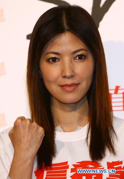 Taiwan singer Jane Chan receives an interview during the 'Fight and Smile' fund-raising party for the earthquake-hit Japan held in Taipei, southeast China's Taiwan, March 18, 2011.