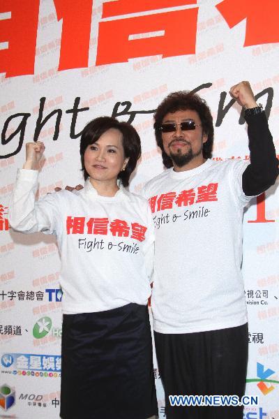 Taiwan artists Jennifer (L) and Fei Chang (R) pose a gesture encouraging Japanese people during the 'Fight and Smile' fund-raising party for the earthquake-hit Japan held in Taipei, southeast China's Taiwan, March 18, 2011.