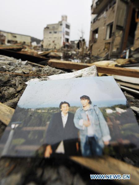 A picture lies among the debris from the March 11 tsunami and earthquake, in the city of Kesennuma in Miyagi prefecture, Japan, on March 20, 2011. 