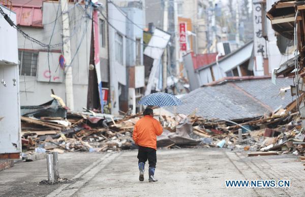 A men walks among the debris from the March 11 tsunami and earthquake in the city of Kesennuma in Miyagi prefecture, Japan, on March 20, 2011. 