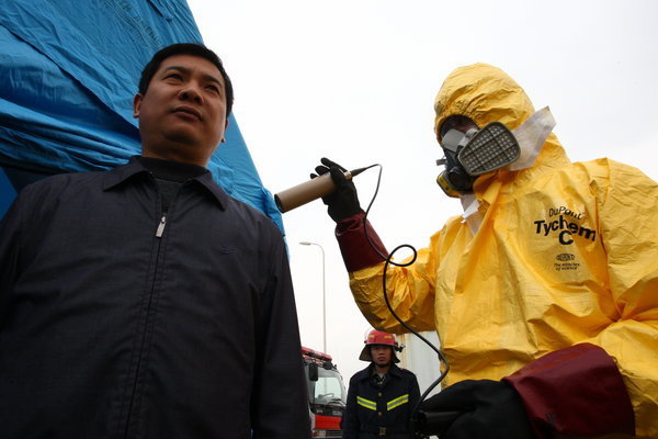 People take part in a nuclear leakage emergency drill at Gaolangang district after after nuclear leakage in Japan on March 17, 2011 in Zhuhai, Guanghzou Province of China. 