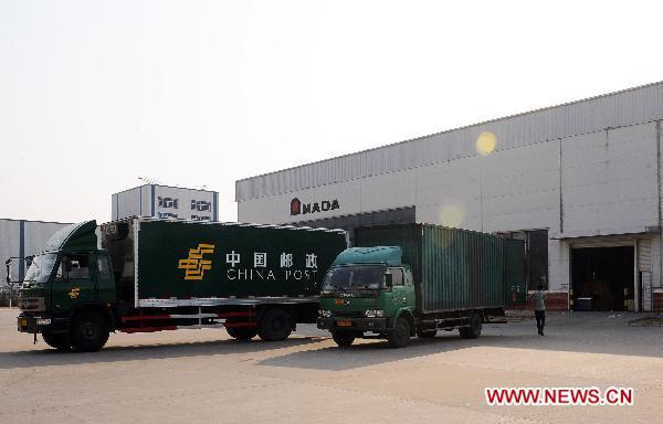 Trucks get loaded at a machine tools factory invested by Japanese company in Lianyungang City, east China's Jiangsu Province, March 18, 2011. 