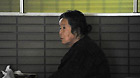 A Japanese woman sits inside a sports park used as a makeshift shelter in Fukushima, Japan, March 19, 2011.