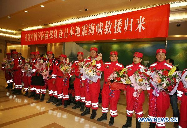 Crew members of the Chinese International Search and Rescue Team (CISAR) are seen during a welcome-home ceremony at the Capital Airport in Beijing, capital of China, March 21, 2011.