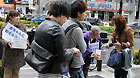 Residents who live in Osaka raise money for earthquake-stricken area on a street in Osaka, Japan, March 21, 2011.