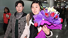 Yi Yanan (R), a trainee of China Dalian International Cooperation (Group) Holdings Ltd., arrives in Dalian, northeast China's Liaoning Province, March 19, 2011.