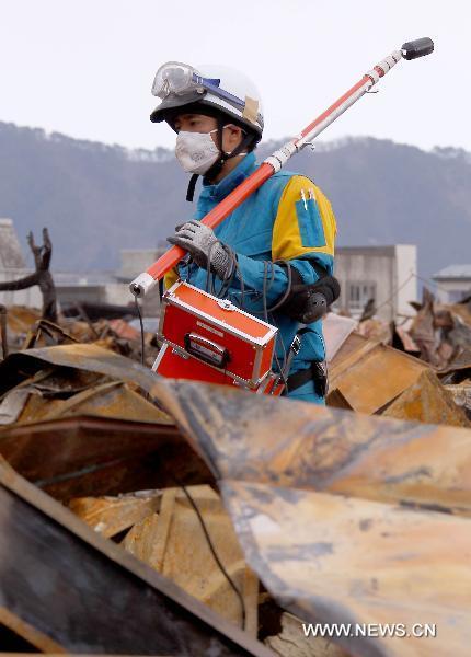 A policeman from Kannagawa Prefecture searches for survivors in quake-devastated Iwate Prefecture, Japan, on March 22, 2011. 