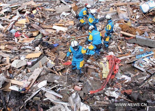 Policemen from Kannagawa Prefecture search for survivors in quake-devastated Iwate Prefecture, Japan, on March 22, 2011.