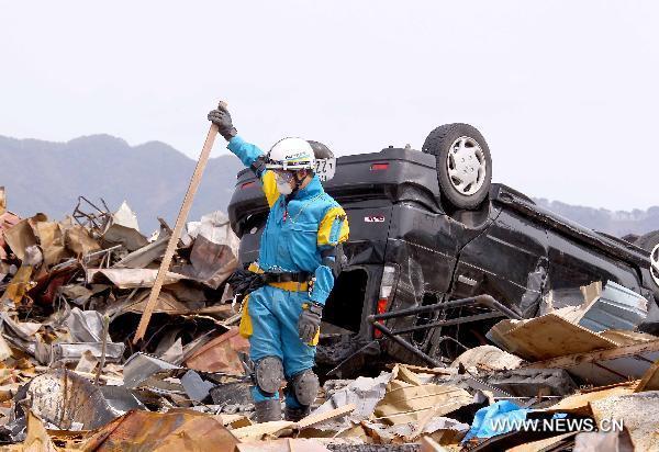A policeman from Kannagawa Prefecture searches for survivors in quake-devastated Iwate Prefecture, Japan, on March 22, 2011.
