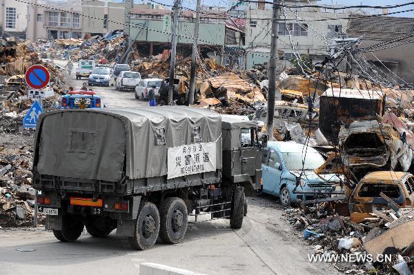 A rescue ambulance drives among the debris in quake-devastated Iwate Prefecture, Japan, on March 22, 2011.