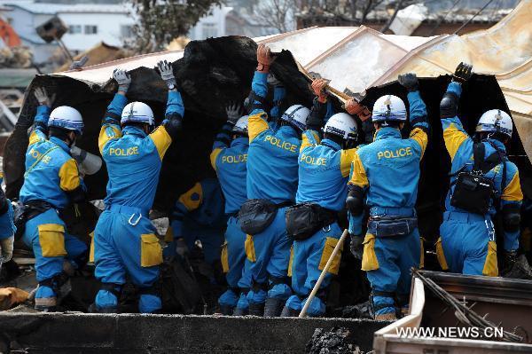 Rescue workers search for survivors in quake-devastated Iwate Prefecture, Japan, on March 22, 2011. 