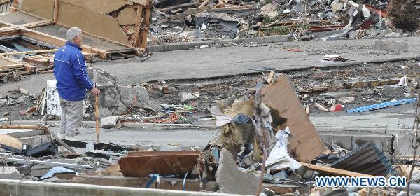 A man looks for his home among debris in quake-devastated Iwate Prefecture, Japan, on March 21, 2011. 