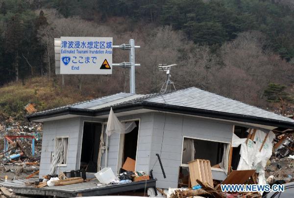 A board reading 'estimated tsunami inundation area ends here' is seen in quake-devastated Iwate Prefecture, Japan, on March 21, 2011. 
