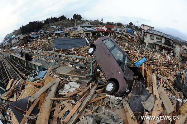This photo taken on March 21, 2011, shows the wrecked vehicle and building debris in Kesennuma, Miyagi-ken in Japan, March 21, 2011.