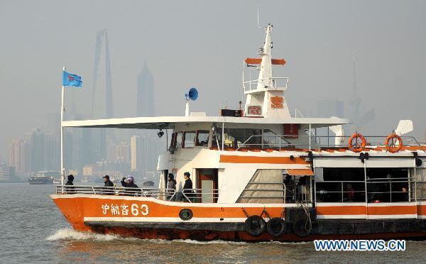 Citizens take a ferry on the Huangpu River in Shanghai, east China, March 28, 2011. 