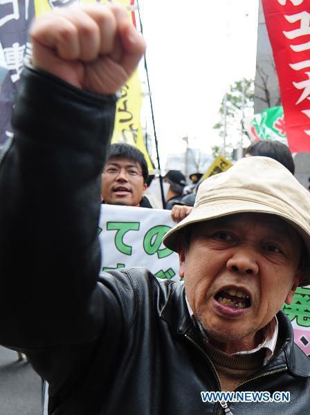 A protester shouts slogans in front of the headquarters of Tokyo Electric Power Company, Inc. (TEPCO) during an anti-nuclear march in Tokyo, Japan, March 31, 2011.