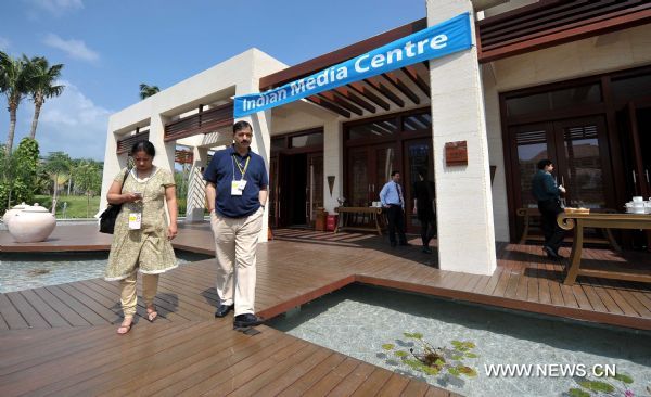 Two Journalists walk out of the Indian Media Centre set up to report the BRICS Leaders Meeting in Sanya, south China's Hainan Province, April 13, 2011.