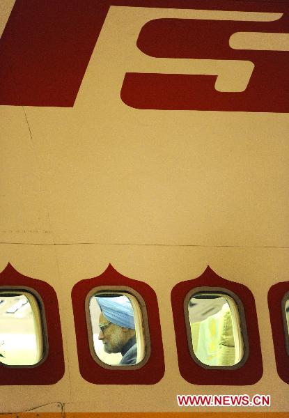 Indian Prime Minister Manmohan Singh is seen on the plane at the airport in Sanya, south China's Hainan Province, April 12, 2011. 