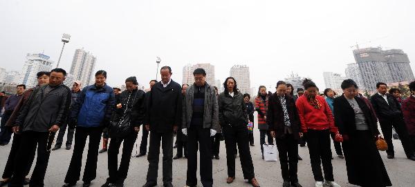 Local people mourn for the victims of the Yushu earthquake at a plaza in Xining, capital of northwest China's Qinghai Province, April 14, 2011. 