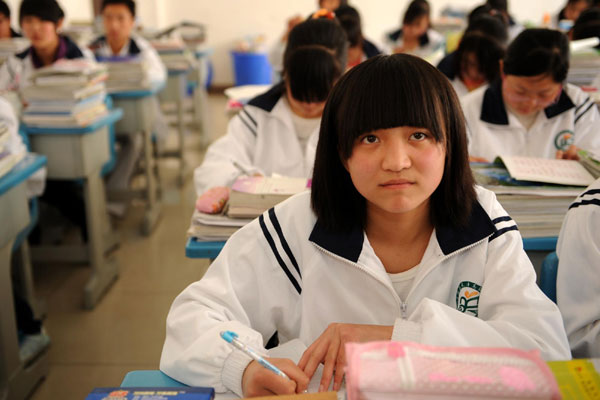 Zhao Shasha listens to her teacher on April 12, 2011, in her hometown Ningqiang, Shaanxi Province.
