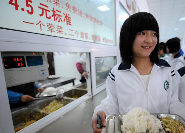 Zhao Shasha buys food in the dinner hall of her school, on April 12, 2011, in her hometown Ningqiang, Shaanxi Province. 