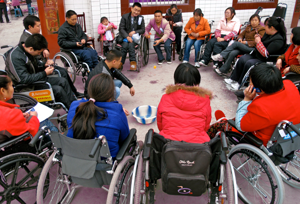 Survivors disabled by spinal cord injuries during the quake play games to overcome isolation through a 26-member peer support group in rural Mianzhu city in this 2011 photo. 