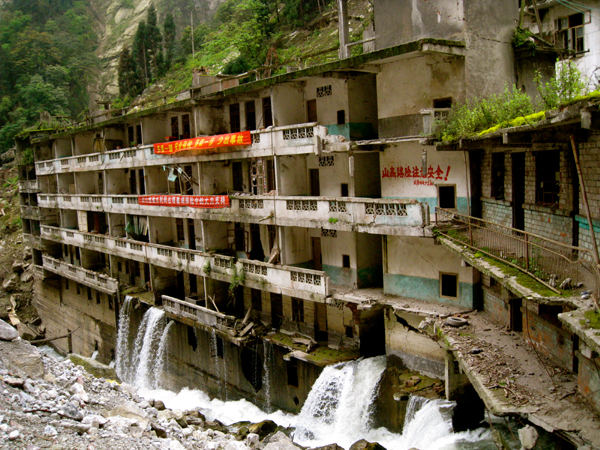 Waterfalls spew from the doorways of the ground floor of an apartment building in Qingping township in Sichuan's Mianzhu city in 2009. 