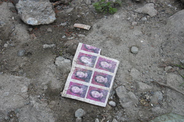 A set of certificate photos is seen on the debris of a deserted shool building that survived the quake on May 12, 2008.